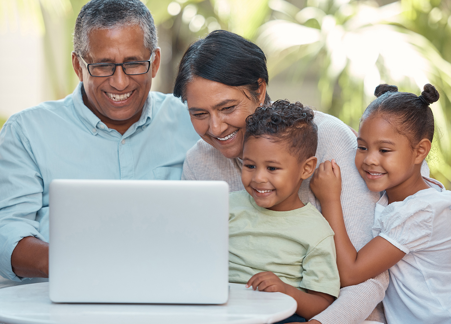 Grandparents, children and laptop on video call with family in house garden or home backyard. Smile.